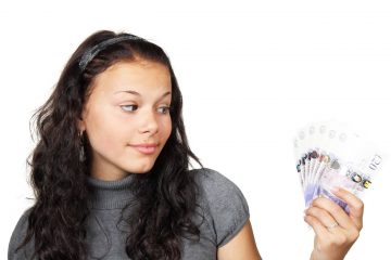 girl holding cash photo in public domain